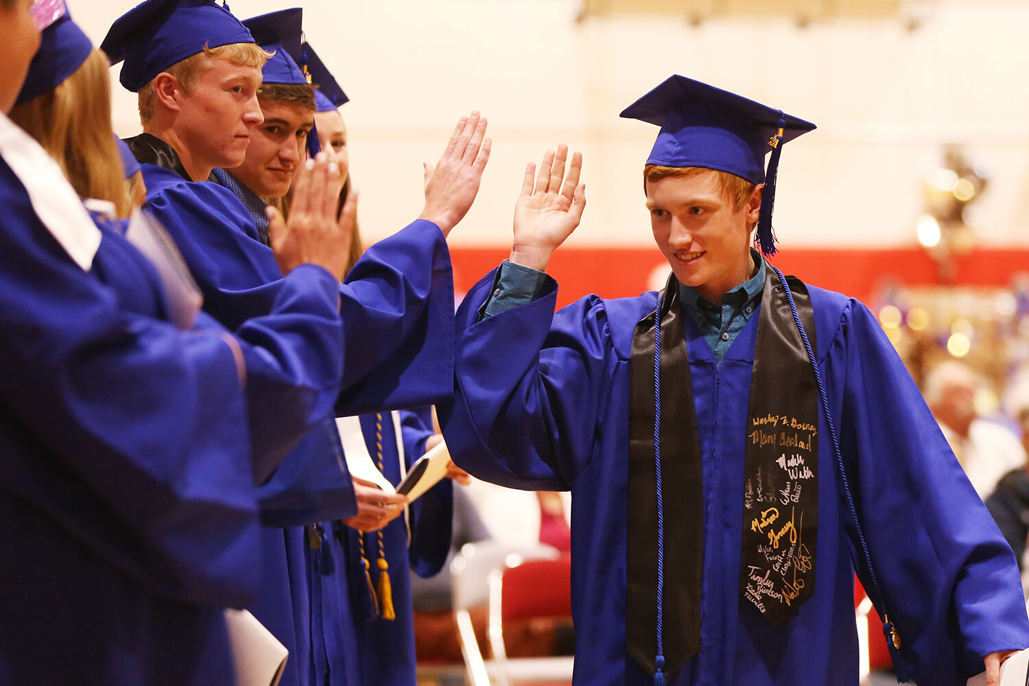 Kade Neville high fives his classmates